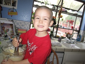 the birthday boy helping make his cupcakes